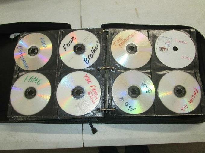 A binder of home-burned DVDs with handwritten labels