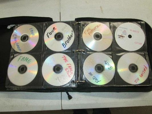 A binder of home-burned DVDs with handwritten labels