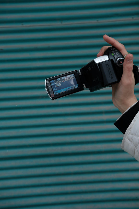 Close-up of a Sony Handycam camcorder with LCD screen open